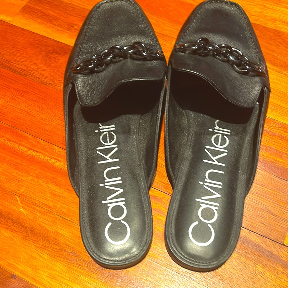 Calvin Klein slides with chain accents.